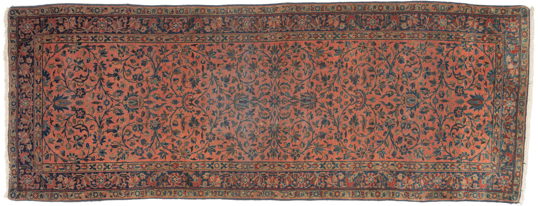 This elegant Kashan runner features a classic allover floral design rendered with remarkable finesse and balance. Set against a warm coral field, scrolling vines, palmettes, and delicate blossoms interlace across the surface in a continuous, harmonious rhythm.
