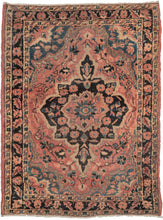 It features of an deep navy central medallion on a crimson ground. The field is filled with fine floral sprays and balanced by four scalloped cornices woven in light blue. The border is composed of a straightforward floral meander in the same deep navy almost black ground of the central medallion. SAROUK PAIR