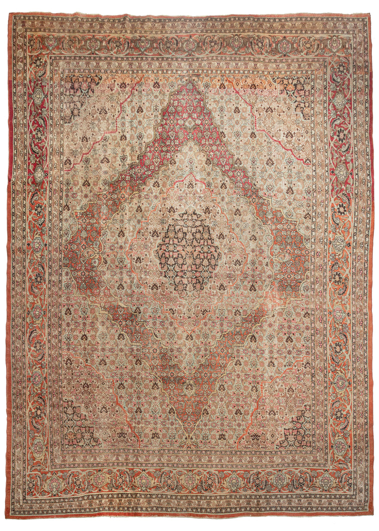 Antique Tabriz oversized rug featuring a central medallion with multiple iterations of the Herati pattern that maintains the same scale but subtly changes color combination to a great visual effect. The repeat Herati emanates in different waves from a dark brown center to soft-toned grounds of ivory, teal, and burnt orange. Four cornices work in the opposing direction and reflect color the exchange found in the center. 