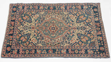 A finely woven small Tabriz rug with a compact medallion composition set against a softly toned field. The drawing is crisp and balanced, with scrolling floral motifs and subtle geometric accents that feel refined rather than busy at this intimate scale.