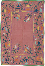 This rare small-format suzani was handcrafted in either the Nurata or Shakhrisabz region of Uzbekistan during the middle of the 19th century.

It is exquisitely embroidered in silk on a luminous cochineal dyed silk ground. The floral composition features scrolling vines and stylized palmettes in rich jewel tones. Likely made as a dowry chest cover or ceremonial cloth this suzani is backed in Russian roller print trade cloth.&nbsp;