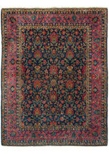 This Luxurious Manchester Keshan Rug features a curvilinear floral motif in rich reds with soft brown branches and lively green leaves on an inky blue ground. It is framed by a perfectly reconciled palmette border with a variety of wonderful blues on a soft pink ground. The composition has been finely executed with silky "manchester" also known as merino wool.