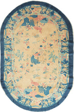 Art Deco handwoven in Tientsin, China This oval-shaped rug features a variety of floral forms and three birds on an unusual sand colored ground.&nbsp;The birds may represent the story of the Fenghuang which began as two different birds, the male Feng and the female Huang which eventually merged to one bird can represent harmony and everlasting love. Framed by a main border that alternates between floral forms and tiered structures with an inner border of ying-yang 