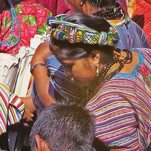 A vibrant woven cinta from Zunil, Quetzaltenango, Guatemala. This long headdress band is brocaded with repeating multicolored motifs, including geometric diamonds and stylized human figures in bright yellow, green, red, and white against a richly patterned ground. The ends finish in twisted multicolored tassels, typical of Zunil weaving.

Cintas are among the most distinctive elements of Maya women’s attire. They are wrapped elaborately around the head, creating a striking crown-like headdress, as seen in t
