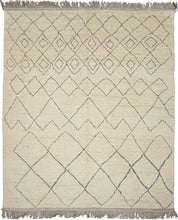 This Moroccan-styled rug was woven during the 21st century in Afghanistan.  It features an idiosyncratic pattern of diamond lattices. that have the feel of pencil quickly scribbled on paper. A simple palette of soft bluish gray lines which almost appear scribbled upon the shaggy cream ground. Woven of hearty, hand-spun Afghan wool giving it durability and extra heft not commonly found in the Moroccan weaving usually associated with this patterning. 