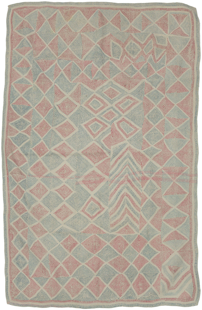 A striking Lahori kantha from the Rajshahi region of Bangladesh, densely worked in running stitch to create an all-over field of shifting diamonds, triangles, chevrons and pinwheel-like forms. The name Lahori or Lohori is generally associated with lahari or lehar, meaning “wave,” a reference to the rhythmic, undulating effect created by its densely repeated geometric stitching rather than to the city of Lahore.
