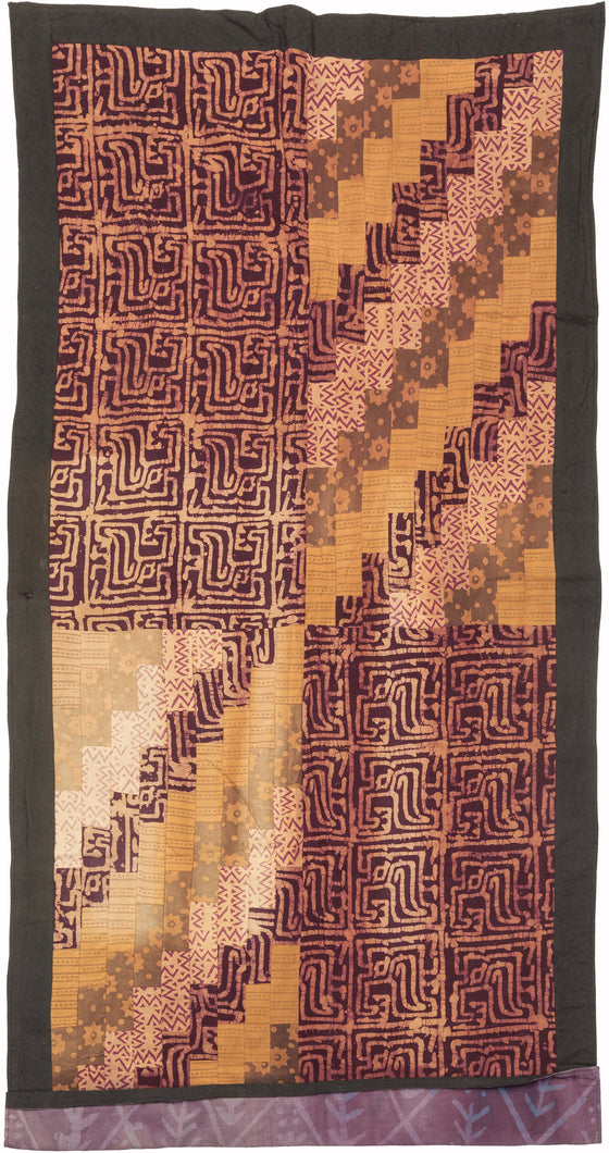 This batik patchwork was crafted in Indonesia during the 20th century.

Batik is a wax-resist technique that creates a distinctive style. This textile features a variety of batik designs that have been patchworked together into four quadrants creating a dynamic design in purples and yellows. 