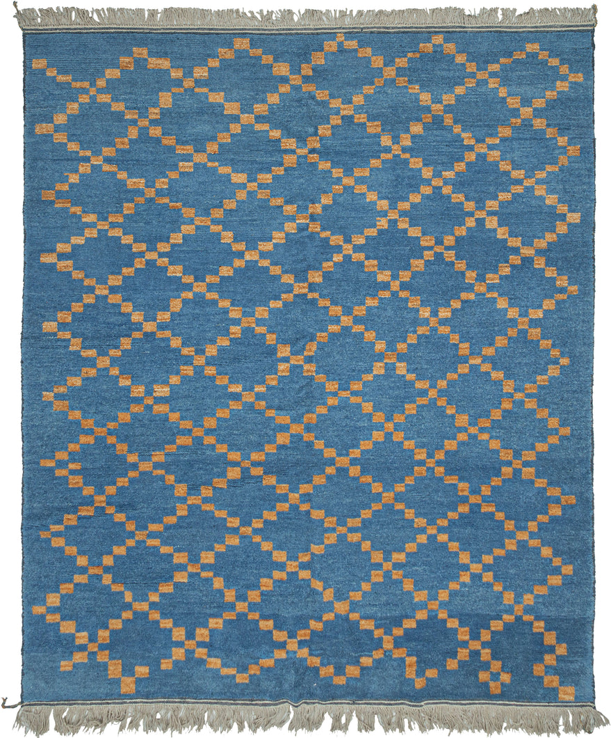 This Moroccan-styled rug was woven during the 21st century in Afghanistan.  It features a simple diamond lattice pattern comprised of speckled gold squares on a cobalt ground. The lattice is consistent but with some subtle nuance in it's rhythm and casually breaks apart near the top and bottom of the rendering. Woven of hearty, hand-spun Afghan wool giving it durability and extra heft not commonly found in the Moroccan weaving usually associated with this patterning. 