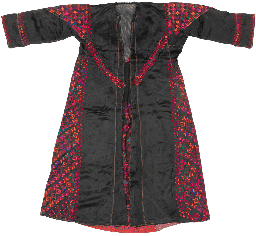 A richly embroidered Palestinian thobe from the central highlands region that includes Ramallah and Jerusalem and is distinguished by its vivid polychrome embroidery set against a dark ground and its balanced, symmetrical composition.