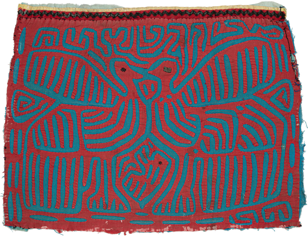 Vintage Mola cloth handmade by the Guna (previously spelled Kuna) people of the San Blas Islands.  Mola is a reverse appliqué technique, similar to the technique used in quilting but using multiple layers of different-colored cloth that are first sewn together before a design is created by cutting away different layers.  This Mola features two birds and a baby chick.  The fabric is in good condition with some fraying around the edges