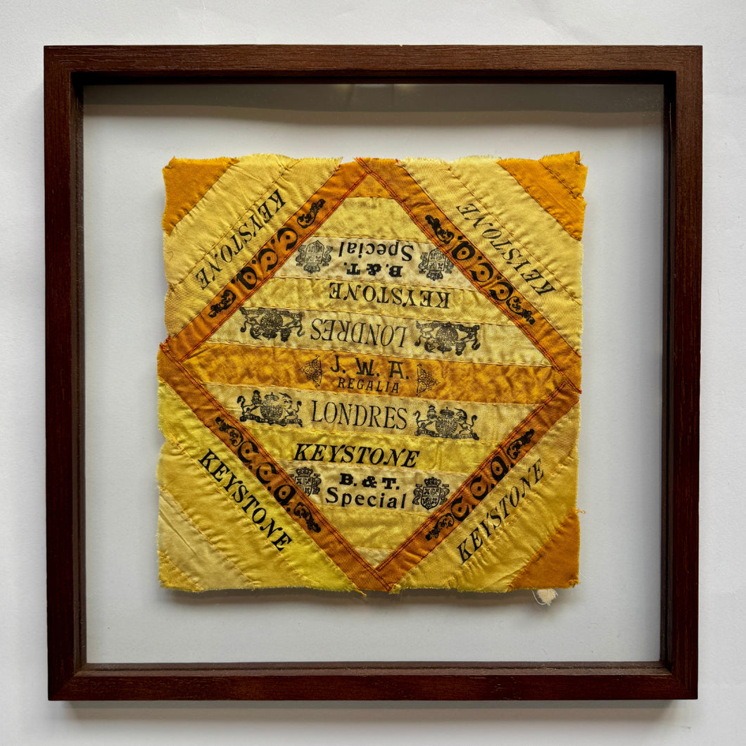 This quilts were handcrafted in United States during the turn of the 20th century.

These hand-stitched quilt panels are made from silk cigar ribbons. These pieces reflect a unique chapter in American domestic craft, when women repurposed decorative silk bands that had been used to bundle cigars into quilts, pillows and other textile art. The brand names, including Harvard, Blackstone, and Londres Extra, are framed in bold type and bright tones of yellow and orange, capturing the visual language