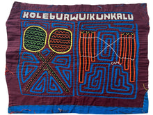 Vintage Mola cloth handmade by the Guna (of the San Blas Islands.  Mola is a reverse appliqué technique, similar to the technique used in quilting but using multiple layers of different-colored cloth that are first sewn together before a design is created by cutting away different layers. These cloths are traditionally made in pairs to be worn on the front and back of women's blouses.  This Mola features a both maracas and a pan flute which are traditionally played by the Guna people.