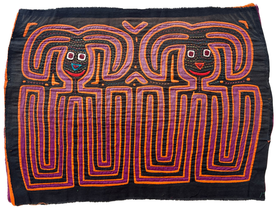 Vintage Mola cloth handmade by the Guna (previously spelled Kuna) people of the San Blas Islands.  Mola is a reverse appliqué technique, similar to the technique used in quilting but using multiple layers of different-colored cloth that are first sewn together before a design is created by cutting away different layers. These cloths are traditionally made in pairs to be worn on the front and back of women's blouses.  This Mola features what appear to be two bunnies.