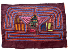 Vintage Mola cloth handmade by the Guna (previously spelled Kuna) people of the San Blas Islands.  Mola is a reverse appliqué technique, similar to the technique used in quilting but&nbsp;using multiple layers of different-colored cloth that are first sewn together before a design is created by cutting away different layers. These cloths are traditionally made in pairs to be worn on the front and back of women's blouses.  This Mola features a strange face. 