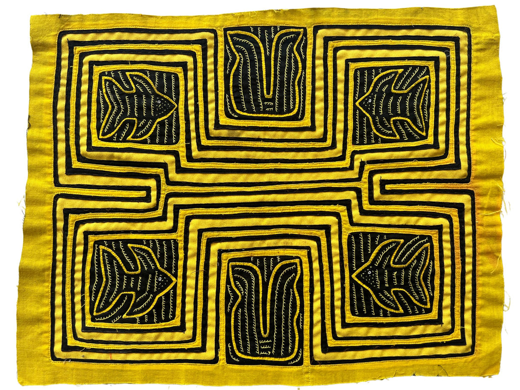 Vintage Mola cloth handmade by the Guna (previously spelled Kuna) people of the San Blas Islands.  Mola is a reverse appliqué technique, similar to the technique used in quilting but using multiple layers of different-colored cloth that are first sewn together before a design is created by cutting away different layers. These cloths are traditionally made in pairs to be worn on the front and back of women's blouses.  This Mola features four fish and what are likely sea plants on a yellow ground. 