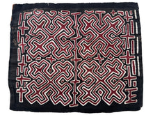 Vintage Mola cloth handmade by the Guna (previously spelled Kuna) people of the San Blas Islands.  Mola is a reverse appliqué technique, similar to the technique used in quilting but&nbsp;using multiple layers of different-colored cloth that are first sewn together before a design is created by cutting away different layers. These cloths are traditionally made in pairs to be worn on the front and back of women's blouses.  This Mola features four quadrants each with a large "X" form.