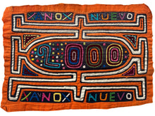 Vintage Mola cloth handmade by the Guna people of the San Blas Islands.  Mola is a reverse appliqué technique, similar to the technique used in quilting using multiple layers of different-colored cloth that are first sewn together before a design is created by cutting away different layers. These cloths are traditionally made in pairs to be worn on the front and back of women's blouses.  This Mola features the words "Ano Nuevo" and "2000" It was most likely made to celebrate the new millennium year 2000