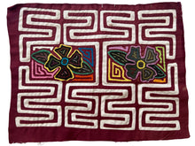 Vintage Mola cloth handmade by the Guna (previously spelled Kuna) people of the San Blas Islands.  Mola is a reverse appliqué technique, similar to the technique used in quilting but&nbsp;using multiple layers of different-colored cloth that are first sewn together before a design is created by cutting away different layers. These cloths are traditionally made in pairs to be worn on the front and back of women's blouses.  This Mola features a two central flowers.  The fabric is in good condition.