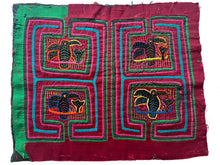 Vintage Mola cloth handmade by the Guna (previously spelled Kuna) people of the San Blas Islands.  Mola is a reverse appliqué technique, similar to the technique used in quilting but using multiple layers of different-colored cloth that are first sewn together before a design is created by cutting away different layers. These cloths are traditionally made in pairs to be worn on the front and back of women's blouses.  This Mola features four panels each featuring a hummingbird drinking nectar from a flower.