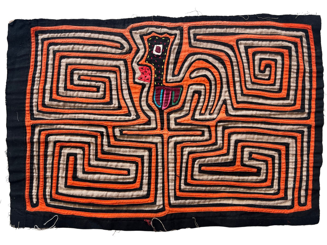 Vintage Mola cloth handmade by the Guna (previously spelled Kuna) people of the San Blas Islands.  Mola is a reverse appliqué technique, similar to the technique used in quilting but using multiple layers of different-colored cloth that are first sewn together before a design is created by cutting away different layers. These cloths are traditionally made in pairs to be worn on the front and back of women's blouses.  This Mola features an orange rooster.