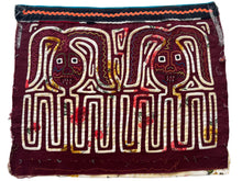 Vintage Mola cloth handmade by the Guna (previously spelled Kuna) people of the San Blas Islands.  Mola is a reverse appliqué technique, similar to the technique used in quilting but&nbsp;using multiple layers of different-colored cloth that are first sewn together before a design is created by cutting away different layers. These cloths are traditionally made in pairs to be worn on the front and back of women's blouses.  This Mola features what appear to be two bunnies. 