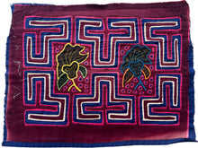 Vintage Mola cloth handmade by the Guna (previously spelled Kuna) people of the San Blas Islands.  Mola is a reverse appliqué technique, similar to the technique used in quilting but&nbsp;using multiple layers of different-colored cloth that are first sewn together before a design is created by cutting away different layers. These cloths are traditionally made in pairs to be worn on the front and back of women's blouses.  This Mola features two central floral forms surrounded by a maze like motif.