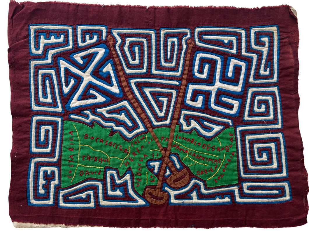 Vintage Mola cloth handmade by the Guna (previously spelled Kuna) people of the San Blas Islands.  Mola is a reverse appliqué technique, similar to the technique used in quilting but using multiple layers of different-colored cloth that are first sewn together before a design is created by cutting away different layers. These cloths are traditionally made in pairs to be worn on the front and back of women's blouses.  This Mola features a map of Panama