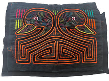 Vintage Mola cloth handmade by the Guna (previously spelled Kuna) people of the San Blas Islands.  Mola is a reverse appliqué technique, similar to the technique used in quilting but&nbsp;using multiple layers of different-colored cloth that are first sewn together before a design is created by cutting away different layers. These cloths are traditionally made in pairs to be worn on the front and back of women's blouses.  This Mola features two duck heads emerging from a geometric pattern.  