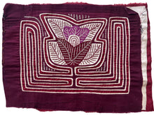 Vintage Mola cloth handmade by the Guna (previously spelled Kuna) people of the San Blas Islands.  Mola is a reverse appliqué technique, similar to the technique used in quilting but&nbsp;using multiple layers of different-colored cloth that are first sewn together before a design is created by cutting away different layers. These cloths are traditionally made in pairs to be worn on the front and back of women's blouses.  This Mola features a central floral motif  The fabric is in very good condition. 