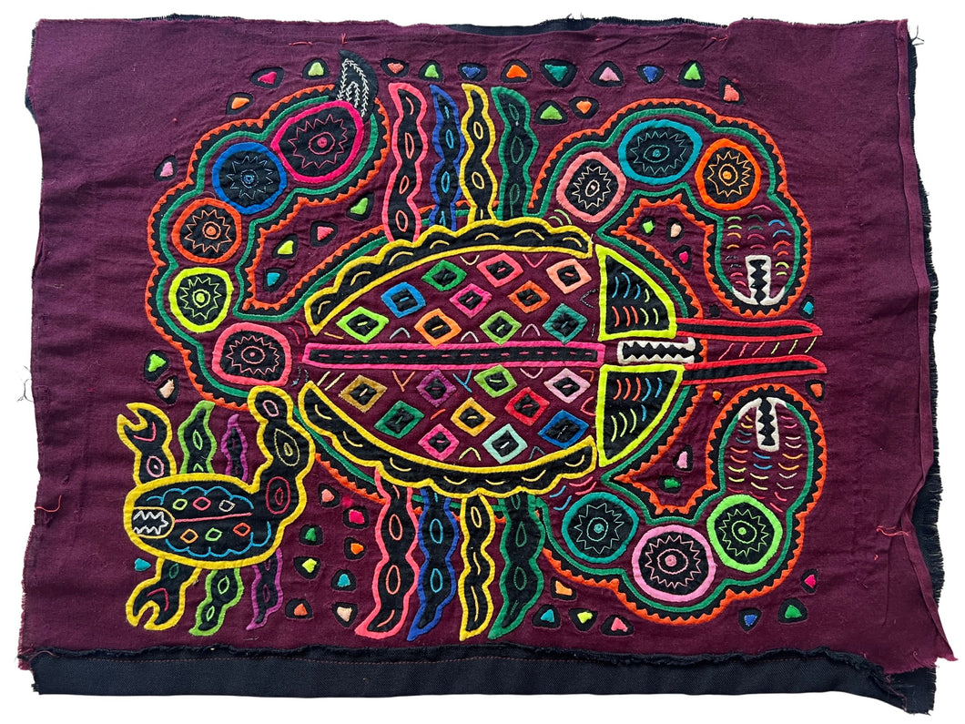 Vintage Mola cloth handmade by the Guna (previously spelled Kuna) people of the San Blas Islands.  Mola is a reverse appliqué technique, similar to the technique used in quilting but using multiple layers of different-colored cloth that are first sewn together before a design is created by cutting away different layers. These cloths are traditionally made in pairs to be worn on the front and back of women's blouses.  This Mola features two scorpions, one small and one large.