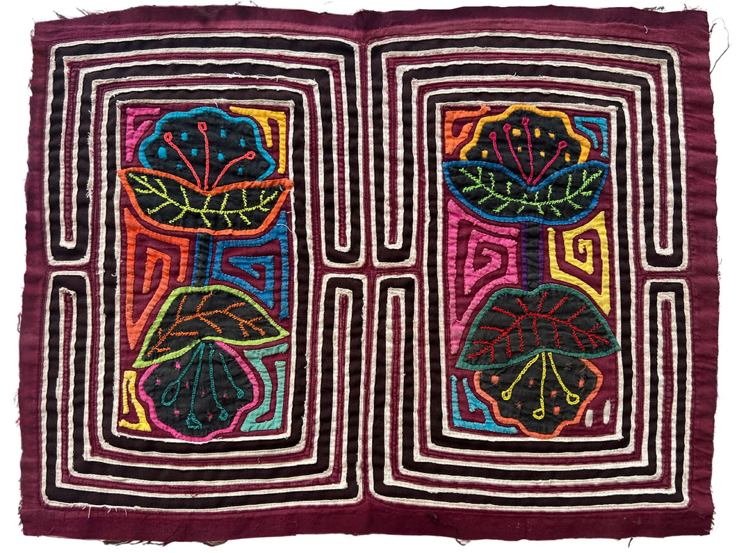 Vintage Mola cloth handmade by the Guna (previously spelled Kuna) people of the San Blas Islands.  Mola is a reverse appliqué technique, similar to the technique used in quilting but using multiple layers of different-colored cloth that are first sewn together before a design is created by cutting away different layers. These cloths are traditionally made in pairs to be worn on the front and back of women's blouses.  This Mola features two pair of of double headed flowers. 