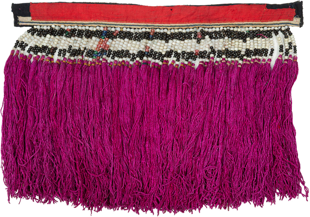 A rare traditional back collar from the Dao Hồng Tụ community of Yên Bái, in the northern highlands of Vietnam. Made as a detachable costume element, this richly ornamented panel would have been worn over a tunic, forming a highly visible expression of Dao identity, artistry, and regional dress tradition.

The collar is constructed with appliquéd red, black, and white cotton, creating a bold geometric band across the top. Rows of antique glass beads are carefully arranged in black and white, with small colo