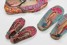 A rare set of embroidered shoes from the Xa Phang people of Dien Bien province in northern Vietnam, including examples for a man, woman, and child. Each pair is constructed with layered textile soles and richly worked uppers, decorated with vivid embroidery in pink, red, green, yellow, blue, and black.

Xa Phang women are known for their highly skilled textile work, and embroidered shoes are among the most expressive parts of traditional dress. The designs follow the community’s established visual vocabular
