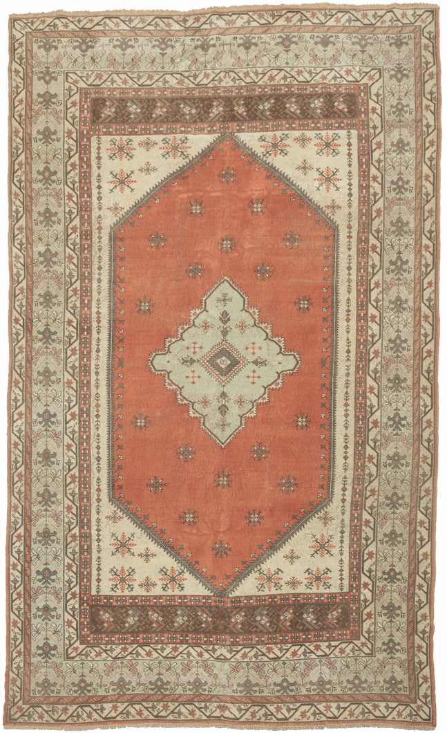 This vintage anatolian rug features a seafoam medallion on a burnt orange ground with ivory cornices. The field and cornices feature well-structured and nicely spaced burr-like forms. The main border features vegetal forms on the same seafoam ground as the central medallion is sandwiched between matching minor borders of scrolling blossoming vines on an ivory ground.  