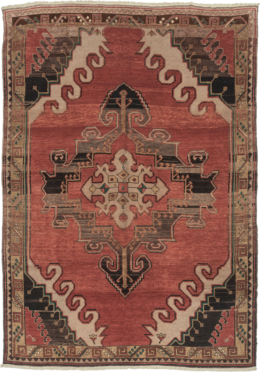Vintage Anatolian Rug features an ornate central medallion on an open raspberry ground. The four graphic cornices feature layers of wave-like latchooks accentuating the strength of the medallion. Framed by a border of scrolling unfurled tendrils.