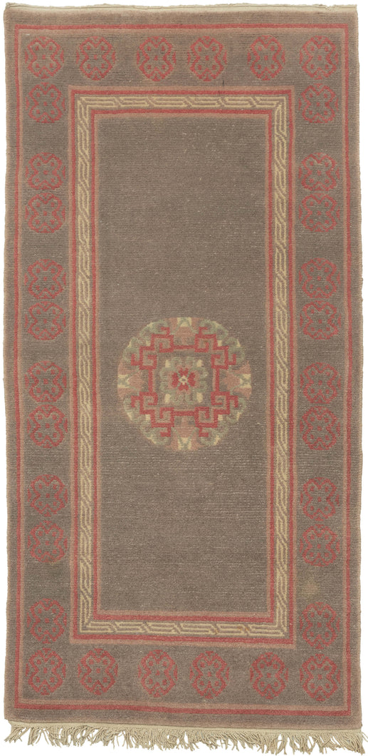 This plush and densely piled rug features a central mandala on open ground. An open and nicely spaced border of X filled orbs frames the perimeter. In a simple palette of pink, cream mauve and faded lilac.