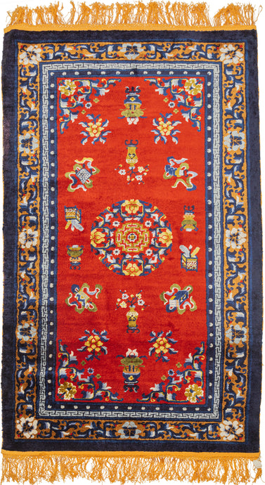 This silk rug was handwoven during the 3rd quarter of the 20th century in Tianjin, China.It features a central lotus mandala on a rich red ground. This red tone is very auspicious and often associated with prosperity. The field is full of other auspicious symbols as well as flower filled vases. The whole is framed by a border of blossoming vines on a golden ground. Nicely finished with golden fringes adding further distinction.