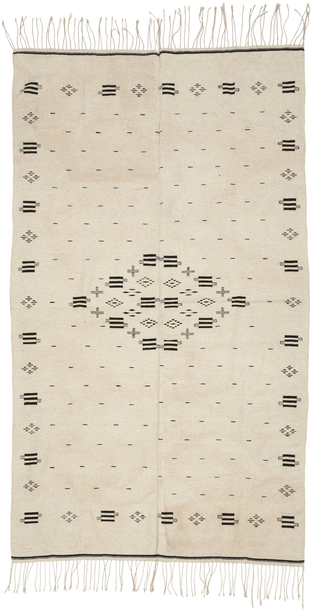 Saltillo serapes are typically celebrated for their explosive color and serrated diamonds, yet this example embodies a far rarer aesthetic restraint. Its monochrome palette highlights the quality of the hand-spun wool and gives the textile a modern presence that feels at home in both historical collections and contemporary interiors.


The graphic language here anticipates the design vocabulary that would later define Mexican modernism. The patterning resonates especially with the iconic Mexico City Olympic