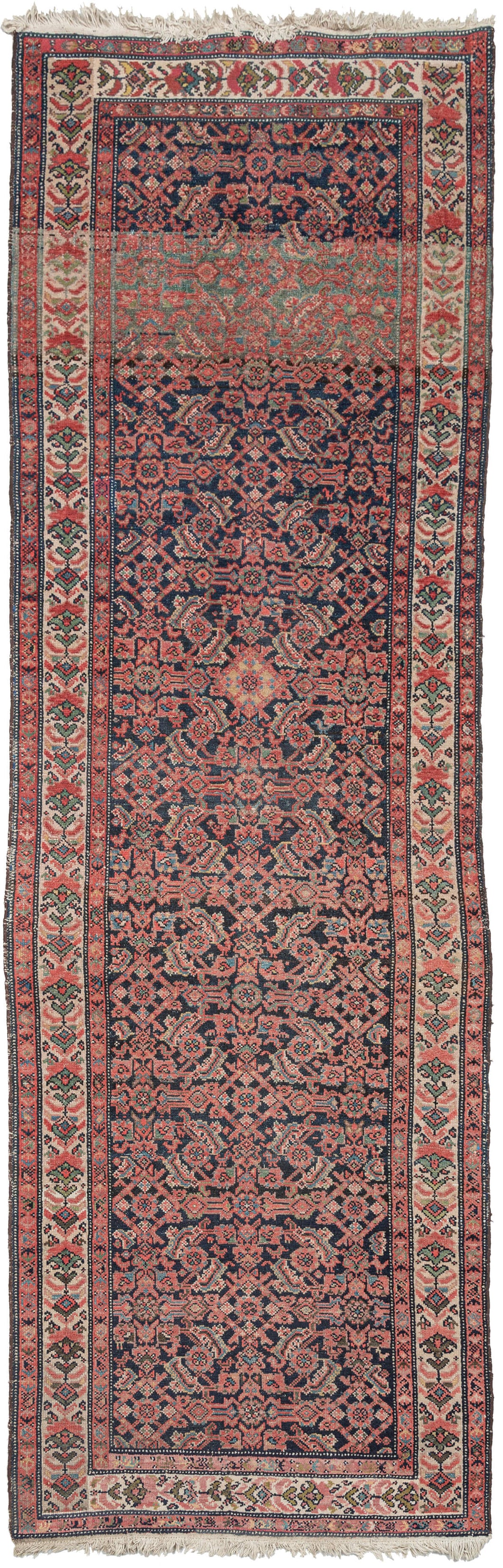 Wide soft red Persian Malayer runner featuring an allover Herati design on a deep indigo blue field. Other colors in the design are bright madder reds, light and dark browns, and soft beiges and ivories. The border is composed of a funky and unusual flower design. 