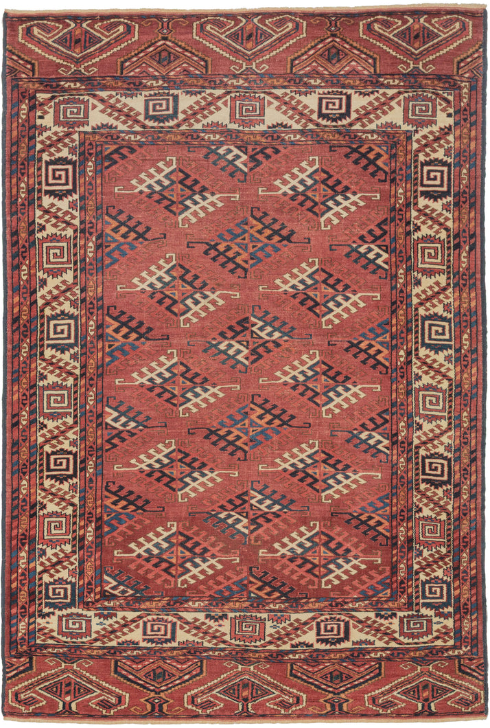 This Yomud Turkmen rug was handwoven during the early 20th century in Western Turkmenistan.

This finely balanced Yomud carpet features a repeating dyrnak-gul field in shades of plum, indigo, ivory, coral, apricot and sky blue. Each diamond-shaped motif radiates a strong tribal geometry, emblematic of Yomud weavings from the Caspian steppe.

