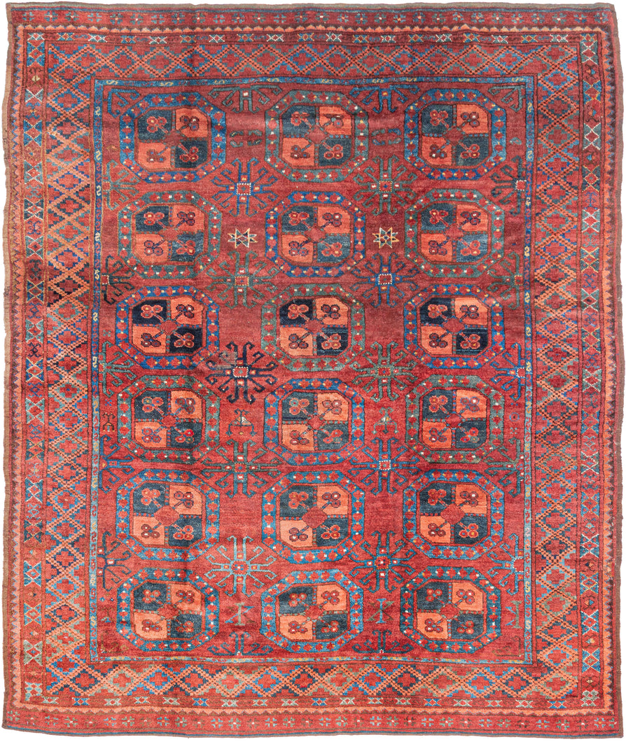 A handsome Ersari Turkmen carpet with a richly saturated madder-red field organized into rows of large octagonal guls, each quartered and filled with small floral devices. Between them, angular cruciform ornaments create a secondary lattice, giving the field an unusually energetic rhythm.