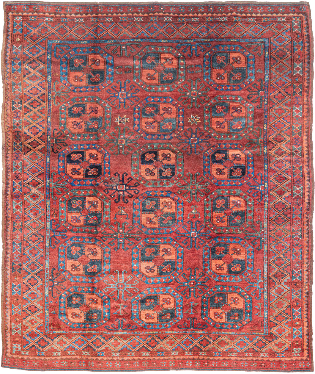 A handsome Ersari Turkmen carpet with a richly saturated madder-red field organized into rows of large octagonal guls, each quartered and filled with small floral devices. Between them, angular cruciform ornaments create a secondary lattice, giving the field an unusually energetic rhythm.