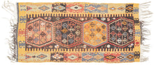 This kilim was handwoven in the Malatalya region of Eastern Anatolian during the early 20th century.

It features a horizontal row of four multi-lobed medallions, each filled with stylized floral motifs. The medallions float on a deep walnut-brown ground, offset by aubergine, apricot, saffron yellow, indigo, soft blues, and madder tones. The surrounding borders alternate hooked amulet forms and diamond devices, creating a rhythmic frame around the central axis.