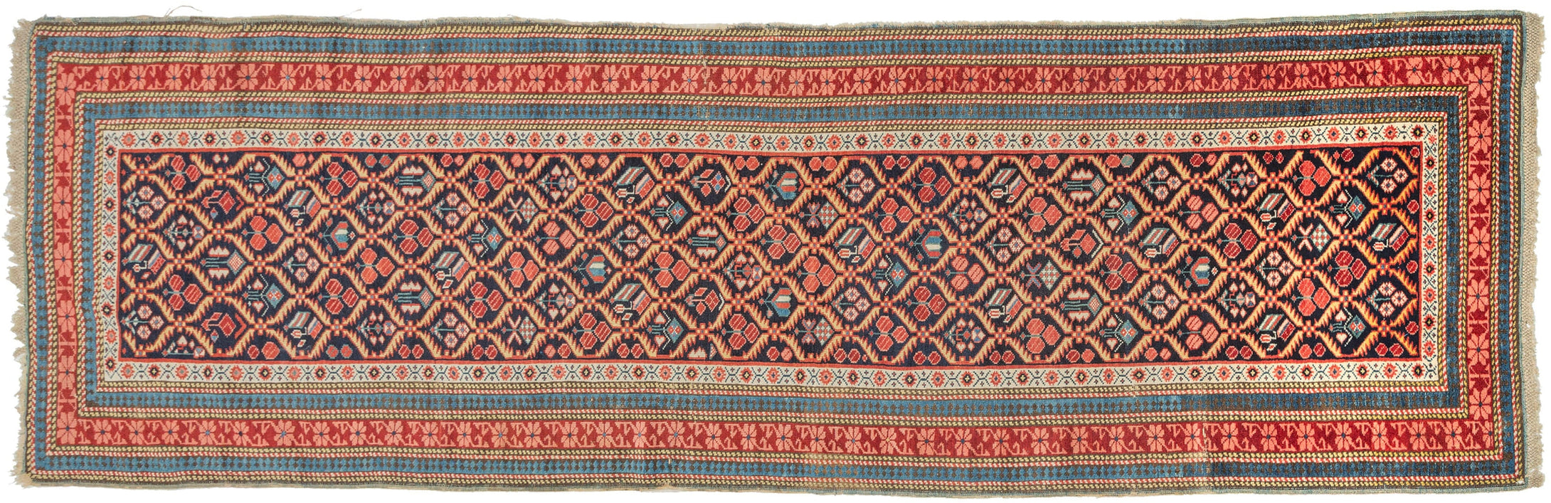 An exceptional example of the Seychour tradition, this runner stands out for the clarity of its drawing, crisp geometry, and refined palette. A tightly organized lattice of abstracted floral forms runs the full length of the field, each element articulated with precision and rhythm that feels both deliberate and energetic.