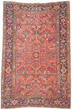 This Heriz rug was handwoven during the second quarter if the 20tb century.&nbsp;

It features an allover field filled with branching angular motifs, stylized palmettes, stepped forms, and curling leaves radiating around a compact medallion. The palette is warm and vibrant, anchored by a rich madder-red ground accented with deep indigo, sky blue, saffron and ivory. The contrast between the crisp drawing and saturated dyes gives the rug a powerful architectural presence without feeling heavy. A beautifully d