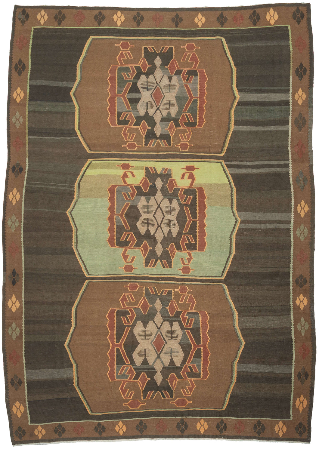 Vintage Kars kilim from eastern Turkey with three geometric medallions in brown and green tones, arranged within an open field with horizontal banding and framed by a border of small repeating diamond motifs.