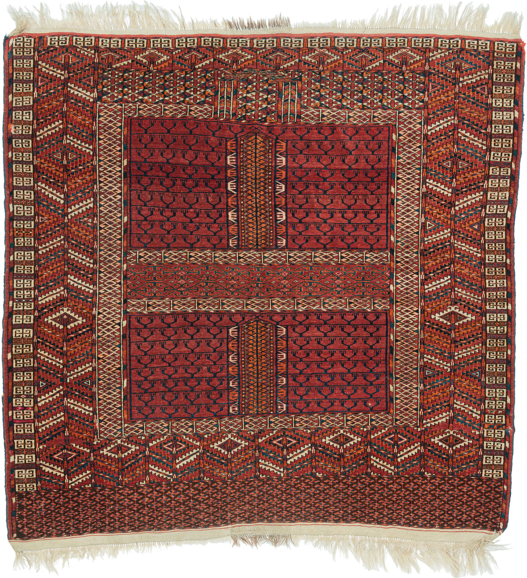 A richly patterned Tekke Turkmen ensi, traditionally woven as a door hanging for the entrance of a yurt. The classic four-part composition gives the piece its architectural quality, with paneled fields, vertical divisions, and layered borders that echo the idea of a threshold.