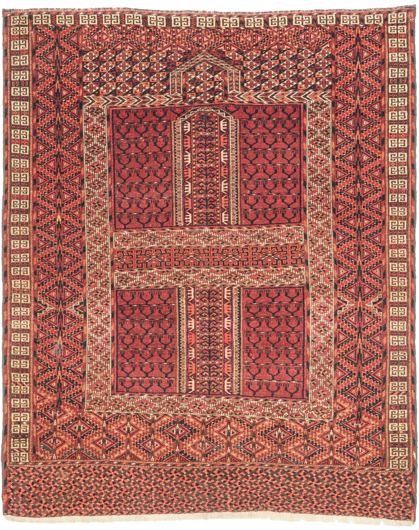 This finely woven Tekke ensi, or door rug, was woven in Southern Turkmenistan during the early 20th century. Its composition follows the traditional four-panel layout divided by a vertical and horizontal axis in a classic Hatchli format. Within each quadrant, stylized tree motifs rise in rhythmic symmetry as abstracted forms that may signify fertility, life, and renewal within the enclosed domestic world.