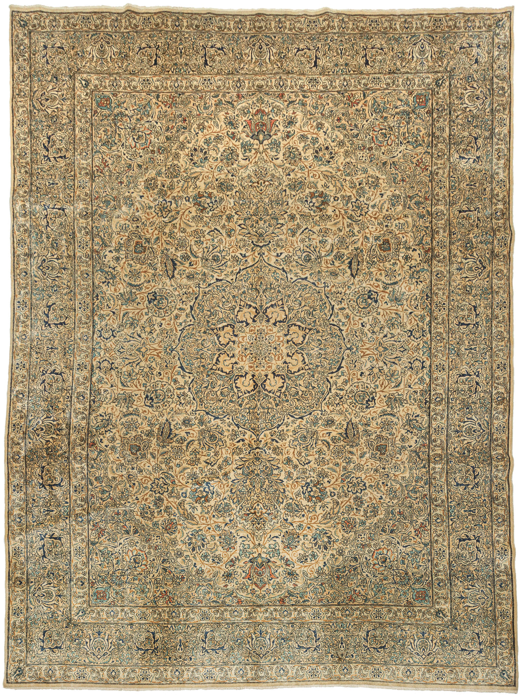 A classic faded Kerman rug with a finely articulated floral field and a soft, balanced palette of warm beige, muted blue, and gentle earth tones. The drawing is intricate yet harmonious, with scrolling vines and rosettes arranged around a calm central medallion that gives the composition focus without heaviness.
