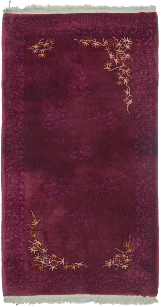 This Art Deco rug was handwoven in Tientsin, China during the second quarter of the 20th century. 

This Deco rug is quite calm and elegant.  An asymmetric inner border of branches and leaf like shapes in autumnal shades provide substance and balance to the delicate tone on tone patterning found in the the field and around the perimeter.